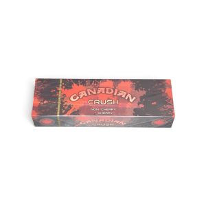 Box of Canadian Crush candy featuring red-black splatter design and a gold vertical ribbon with a maple leaf emblem on the left edge, labeled 'Canadian Crush' with flavor text 'Non-Cherry Cherry'